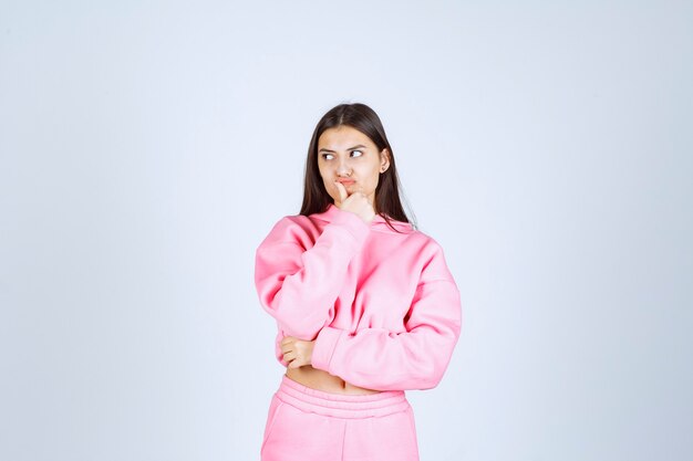 Girl in pink pajamas looks like a fighter and agressive