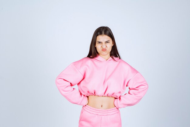 Free photo girl in pink pajamas looks like a fighter and agressive