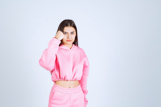 Girl in pink pajamas looks like a fighter and agressive