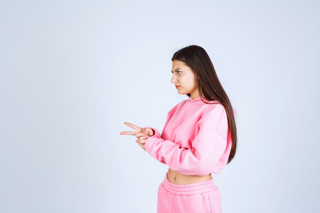 Girl in pink pajamas making very agressive and angry face