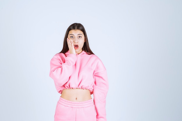 Girl in pink pajamas surprized and shocked