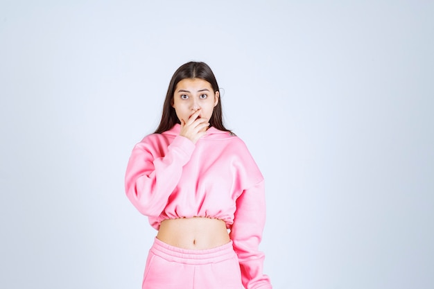 Girl in pink pajamas thinking and analizing