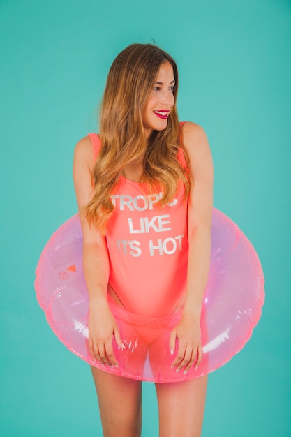 Free photo girl in pink swimsuit with inflatable ring