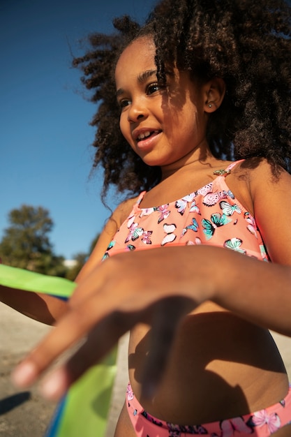 Girl playing on beach side view