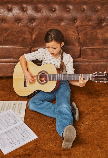 Girl playing guitar at home