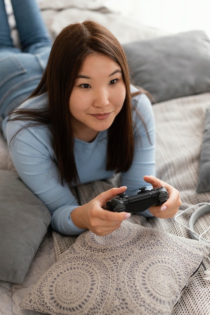 Girl playing videogame medium shot