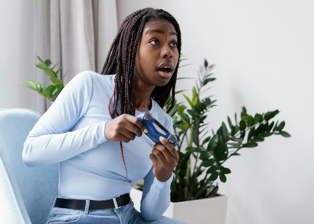 Girl playing videogame with controller