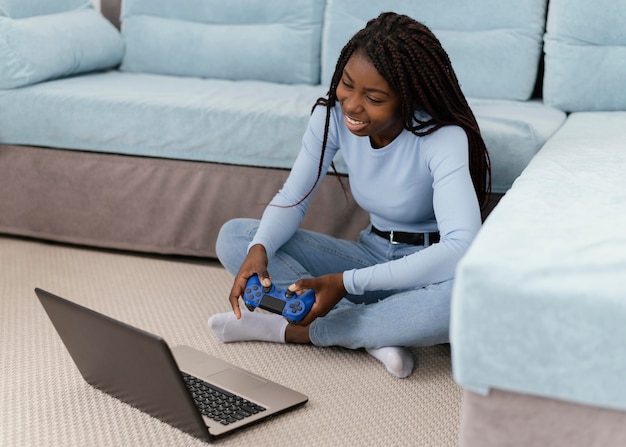 Girl playing videogame with laptop