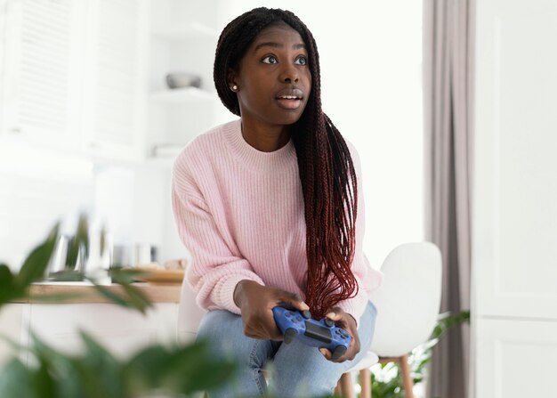 Girl playing videogames at home