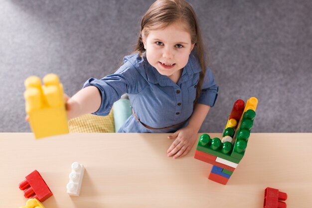 Girl playing with colorful bricks