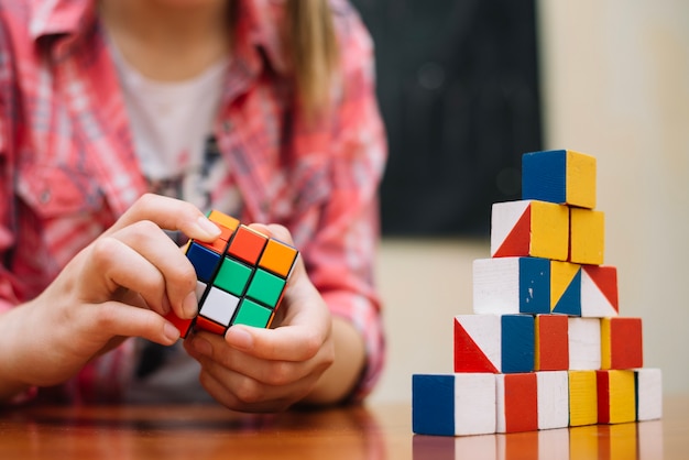 Girl playing with cube puzzle