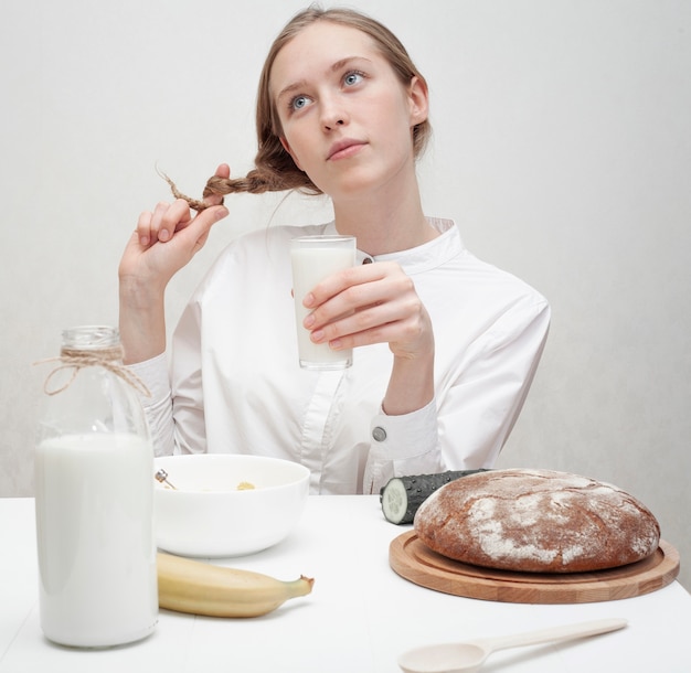 Girl playing with her hair at the table