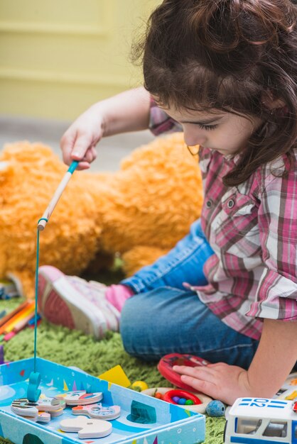 Girl playing with toy fishing rod