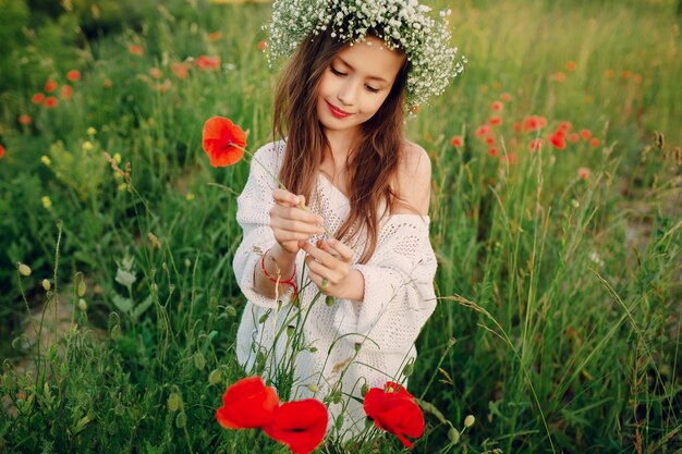 Girl plucking a red flower