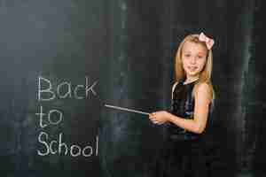 Free photo girl pointing on blackboard