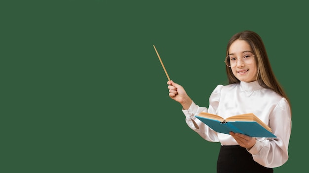 Girl pointing at blackboard