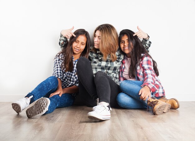 Girl pointing the heads of her friends