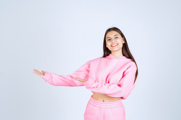 Girl pointing to the left side with emotions at her face