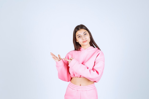 Girl pointing at something in her hand