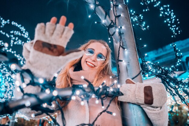 Girl posing against the background of decorated trees