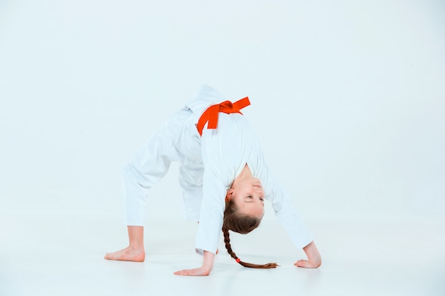 girl posing at Aikido training in martial arts school. Healthy lifestyle and sports concept