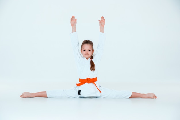The girl posing at Aikido training in martial arts school. Healthy lifestyle and sports concept