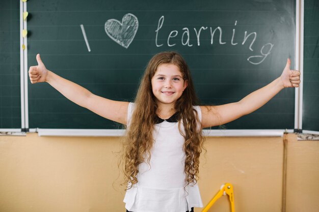 Girl posing at chalkboard