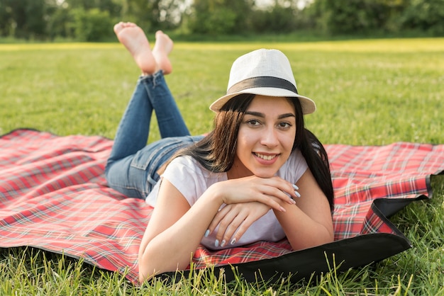 Girl posing on a picnic blanket