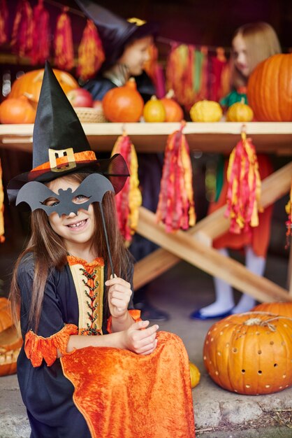 Girl posing with a bat mask
