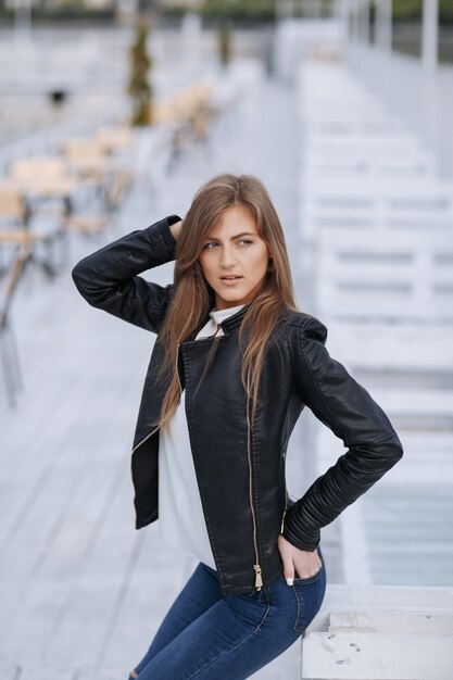 Girl posing with knees bent and one hand on head