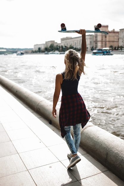 girl posing with skate board