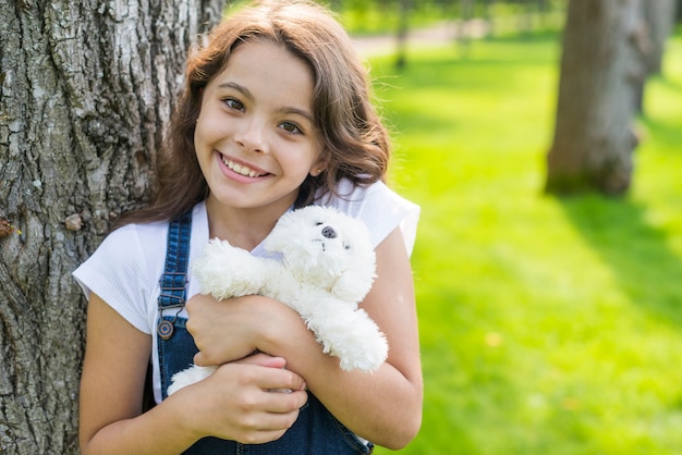 Girl posing with a stuffed toy