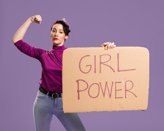 Free photo girl power lettering on cardboard and woman