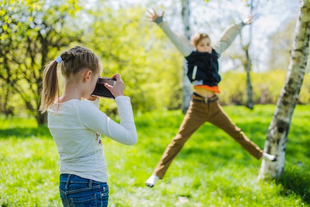 Girl practicing with her camera in the park