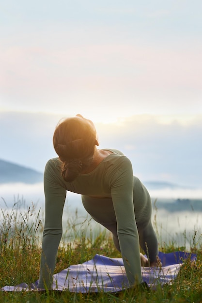 Girl practicing yoga position in nature