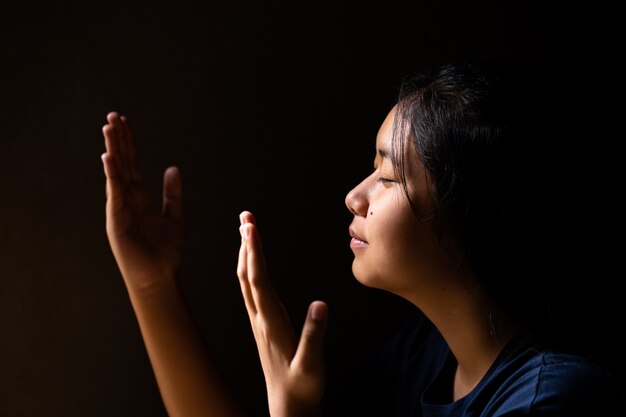 girl praying with her eyes closed