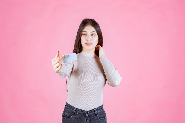 Girl presenting her business card to a business partner