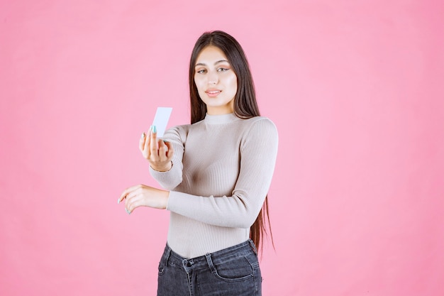 Free photo girl presenting her business card to a business partner