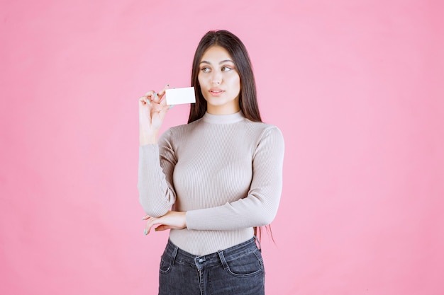 Girl presenting her business card to a business partner