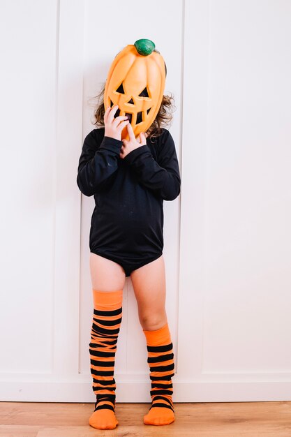 Girl in pumpkin mask