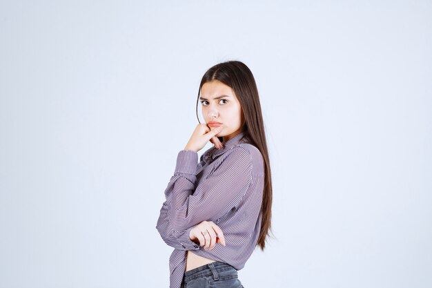 Girl in purple jacket looks serious and thoughful. 