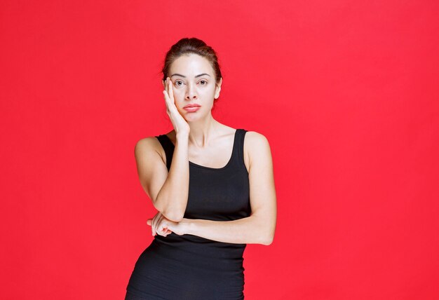 Girl putting hand to her chin and listening attentively. High quality photo