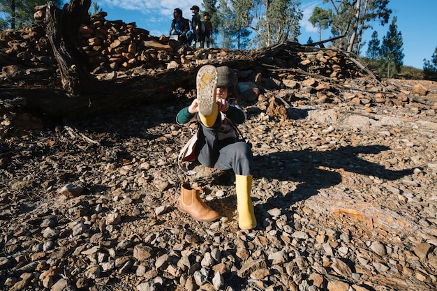 Girl putting on yellow boots