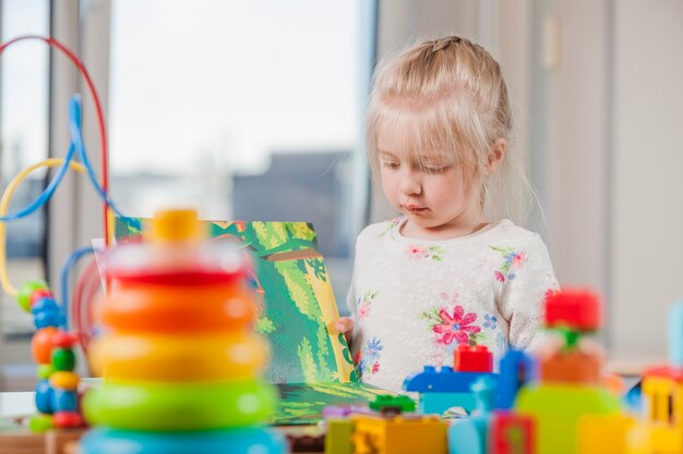 Girl reading book in daycare