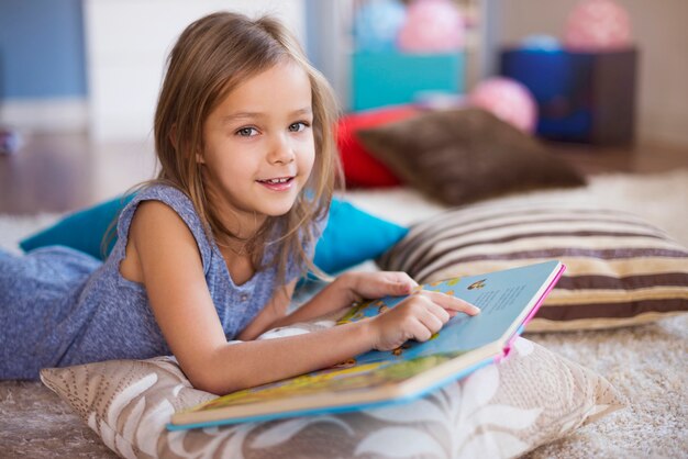 Girl reading in a very comfortable position