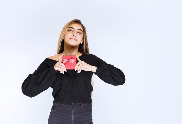 Girl received a red gift box and feeling happy. High quality photo