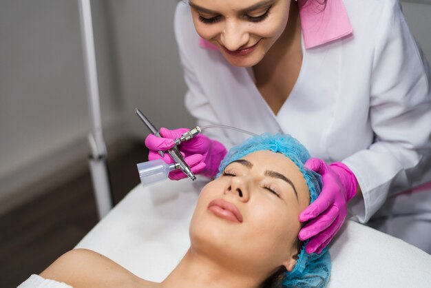 Girl receiving facial treatment in a beauty salon