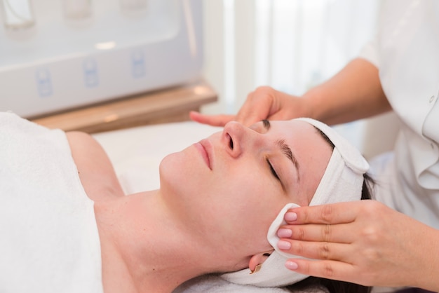 Girl receiving facial treatment in a beauty salon