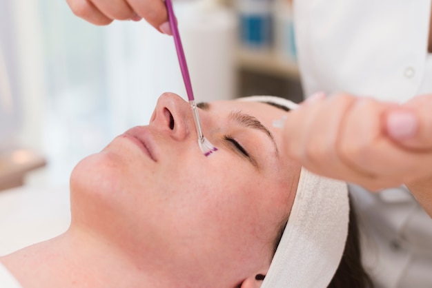 Free photo girl receiving facial treatment in a beauty salon