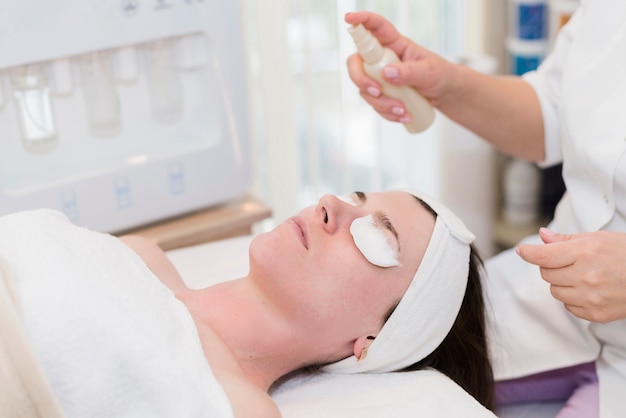 Girl receiving facial treatment in a beauty salon